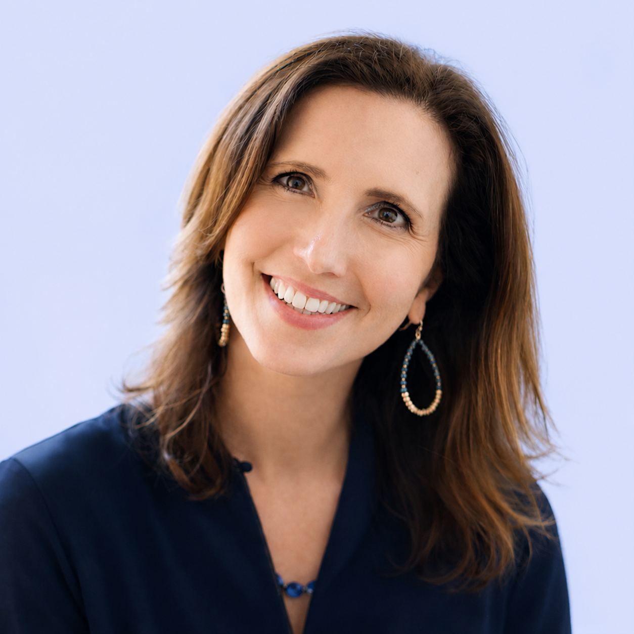 Kerry, founder of LET'S Organise, smiling in a portrait against a soft pale background